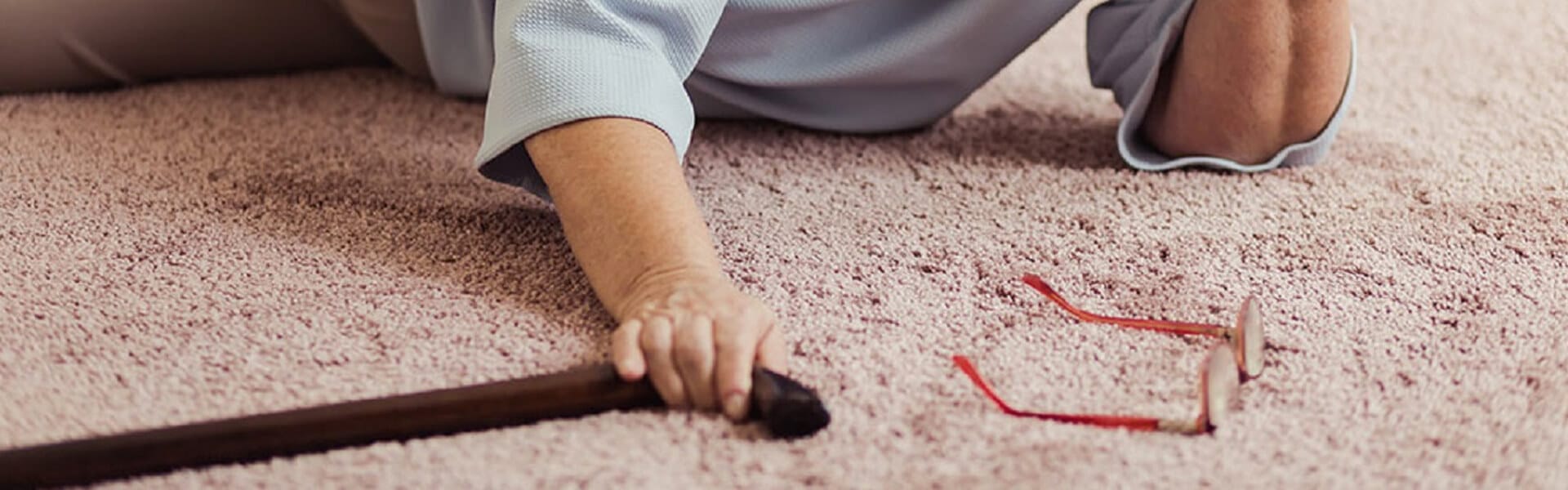 older person laying on carpet following a fallion