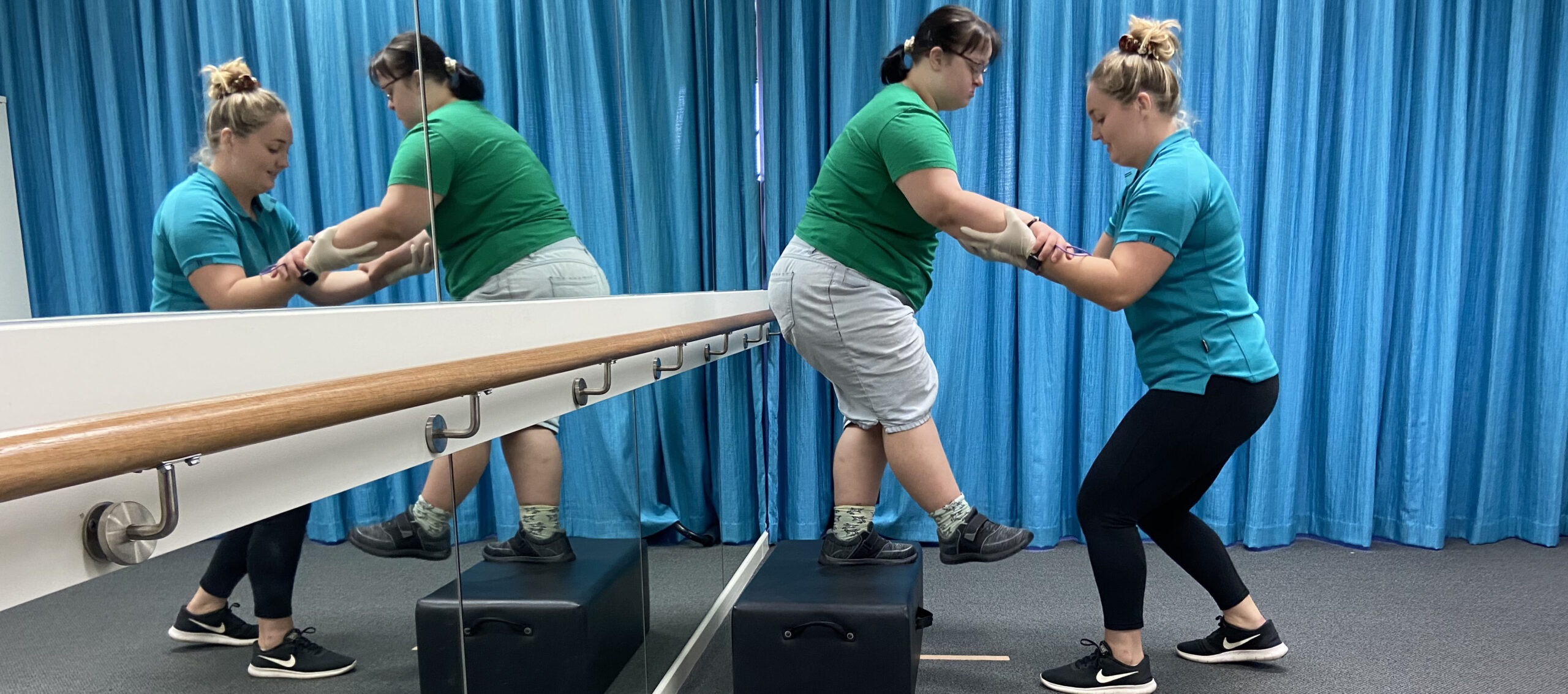 Client being helped off step during therapy session through NDIS registered provider